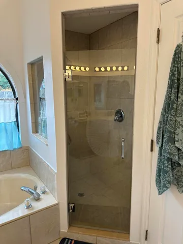 a bedroom with a bed and ceiling fan