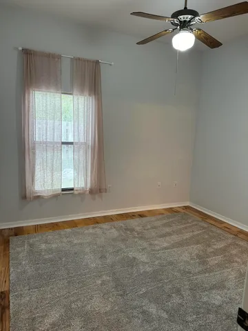 a view of a room with a large window and mirror