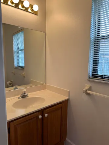 a white toilet sitting next to a small window