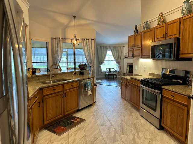 a kitchen with stainless steel appliances a sink stove and cabinets