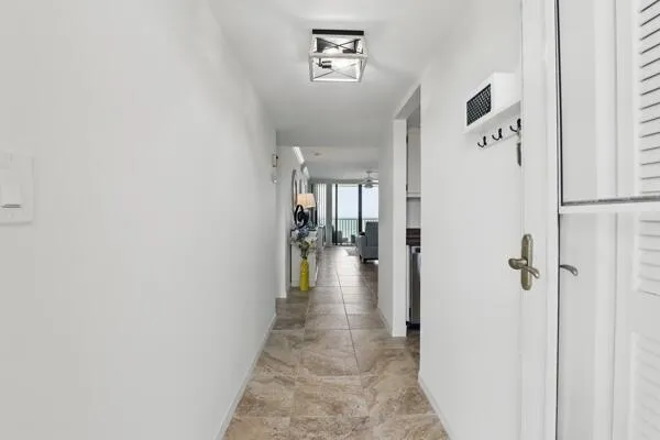 a view of a hallway with a dining area