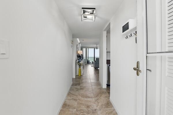 a view of a hallway with a dining area