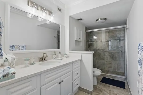 a bathroom with a double vanity sink mirror and toilet