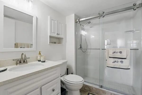 a bathroom with a sink toilet and shower