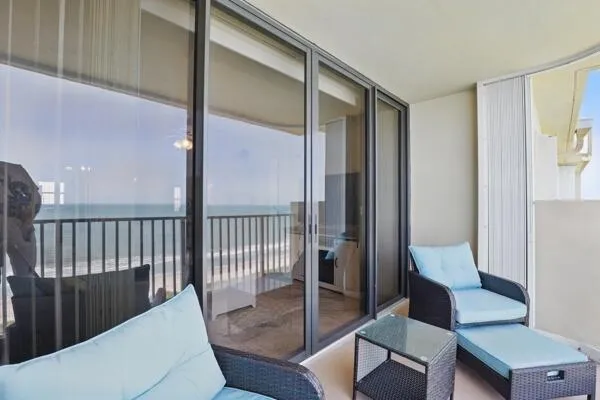 a view of a hallway with furniture and a window