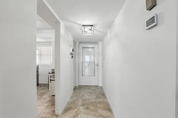 a view of a hallway with wooden shelves