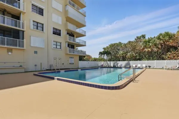 a view of a swimming pool with a buildings in the background