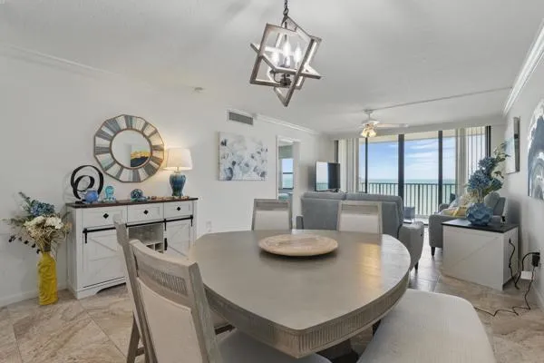a view of a dining room with furniture and chandelier