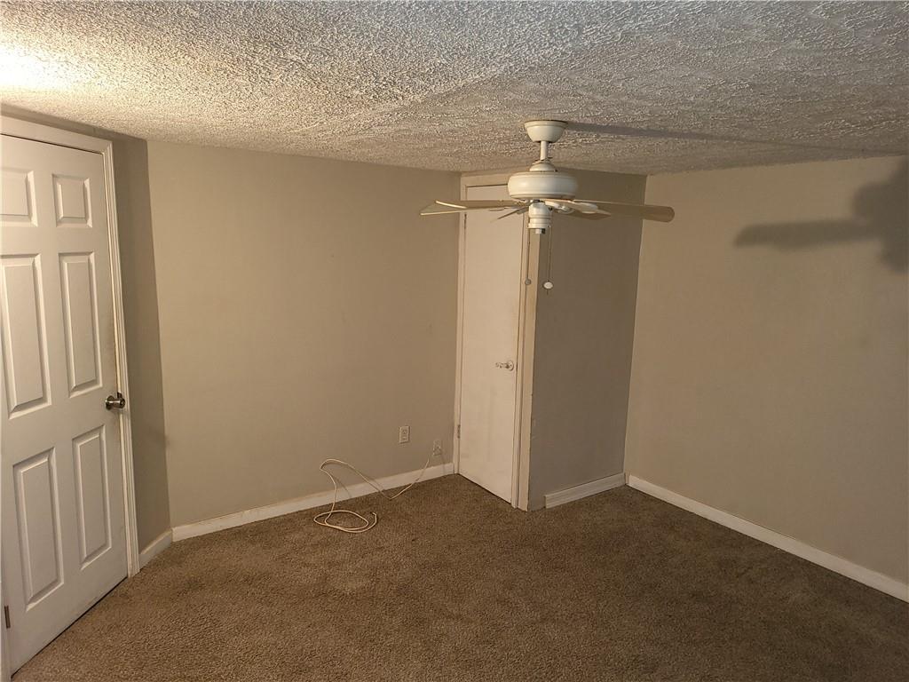 2455 Lake Harbin Road Morrow, GA 30260 - Photo 13 of 28 an empty room with a ceiling fan and a window