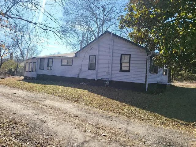 a house with trees in the background