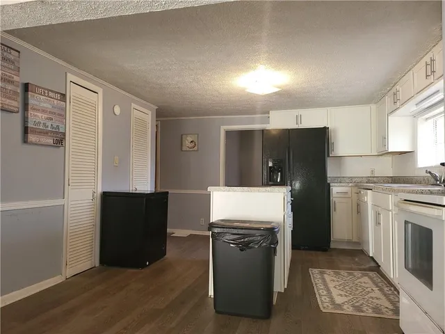 a kitchen with stainless steel appliances granite countertop a refrigerator a stove and a refrigerator