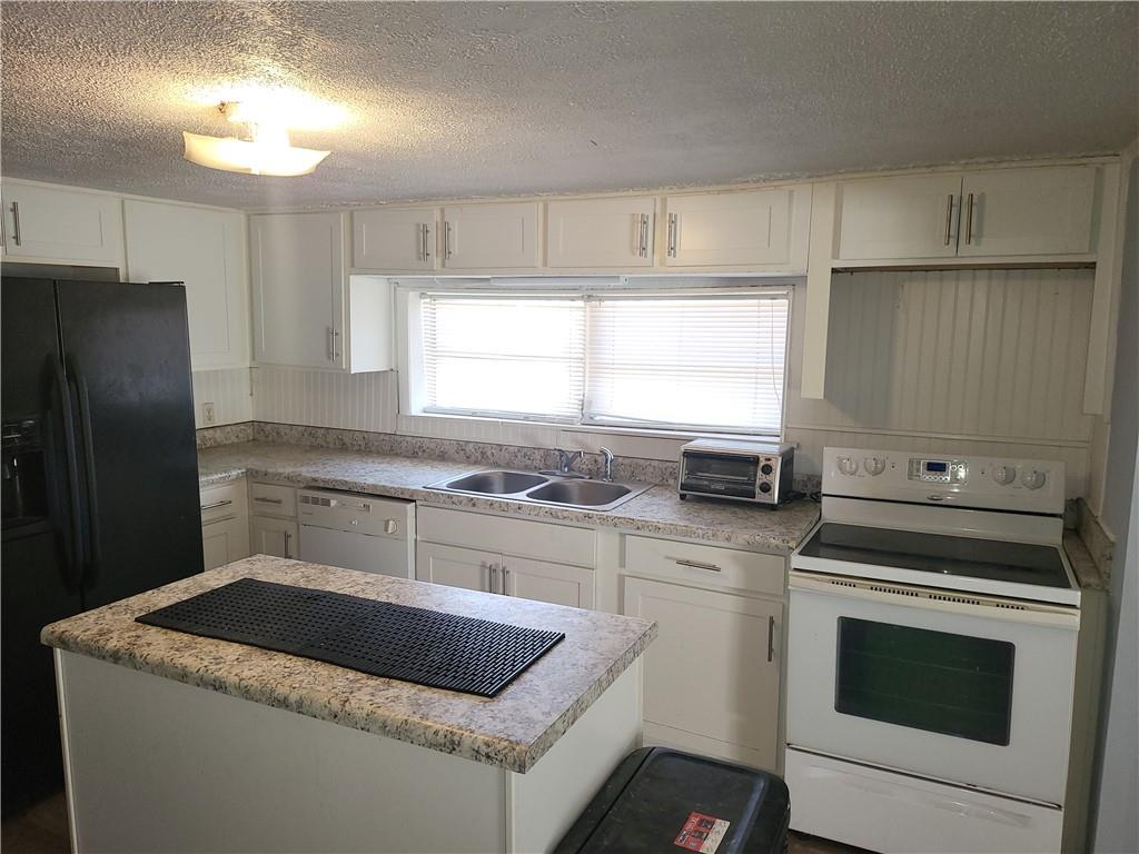 2455 Lake Harbin Road Morrow, GA 30260 - Photo 9 of 28 a kitchen with a stove sink and refrigerator