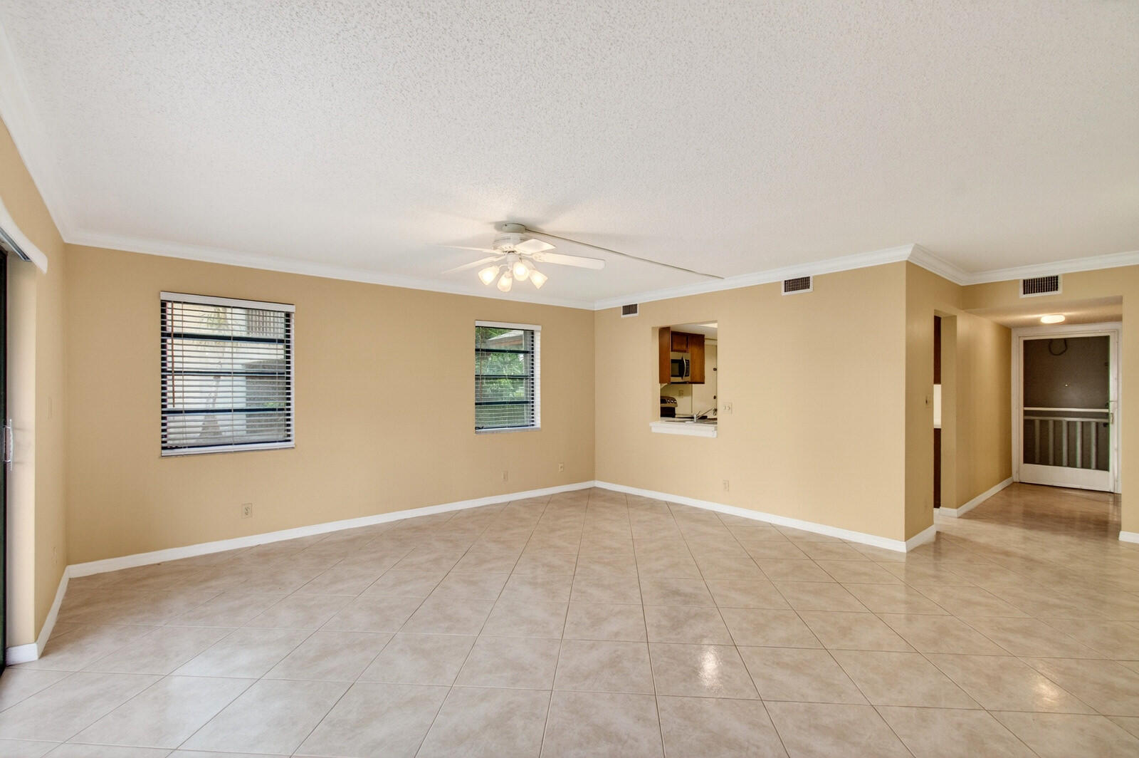 3951 Northeast 19th Road, Unit 1701 Pompano Beach, FL 33064 - Photo 29 of 82 a view of a big room with windows and chandelier fan