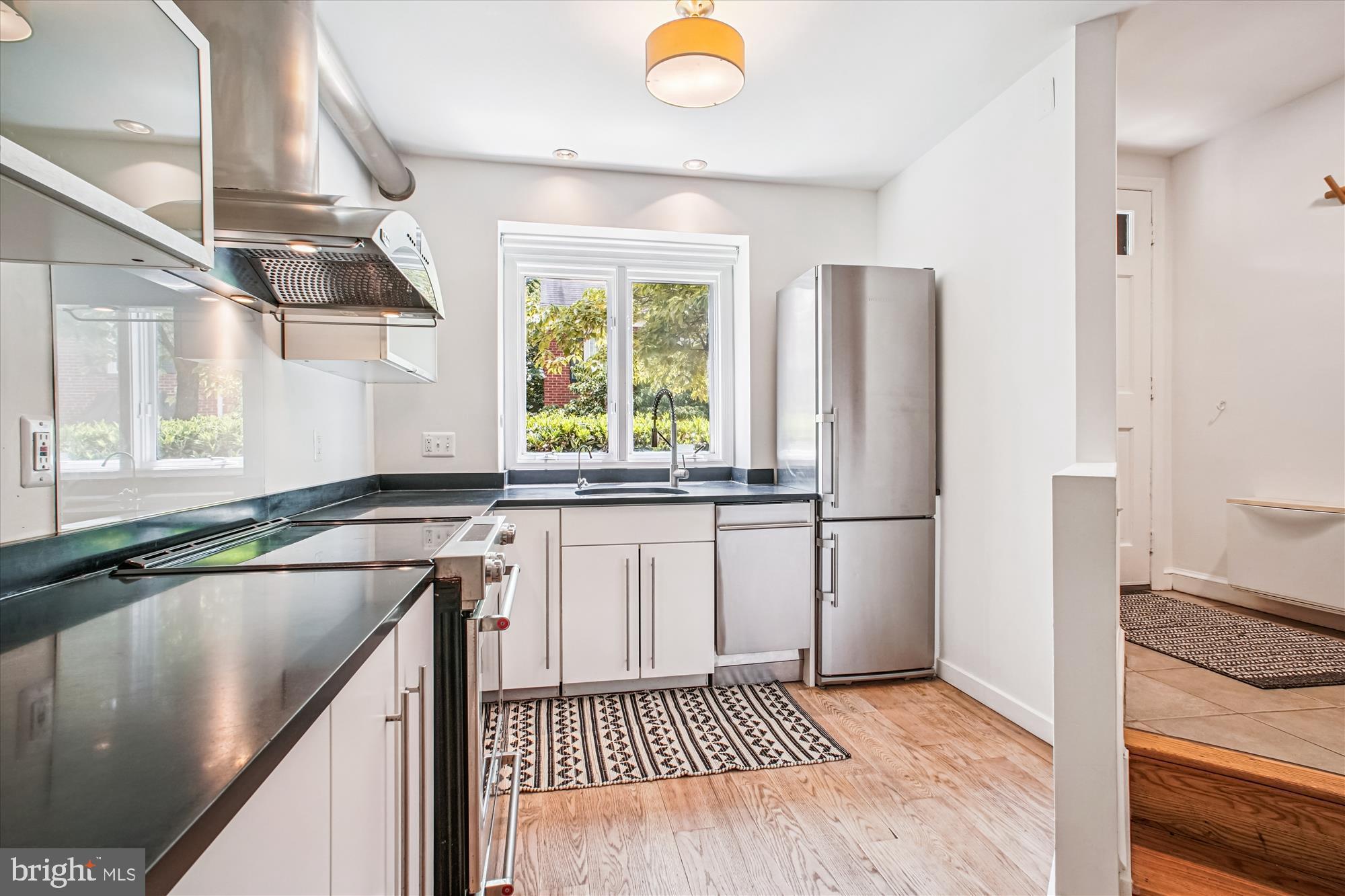 1229 Portner Road Alexandria, VA 22314 - Photo 16 of 47 a kitchen with a refrigerator a sink and a window