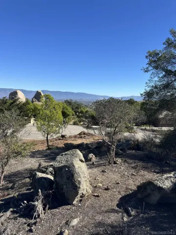a view of a backyard with table and chairs
