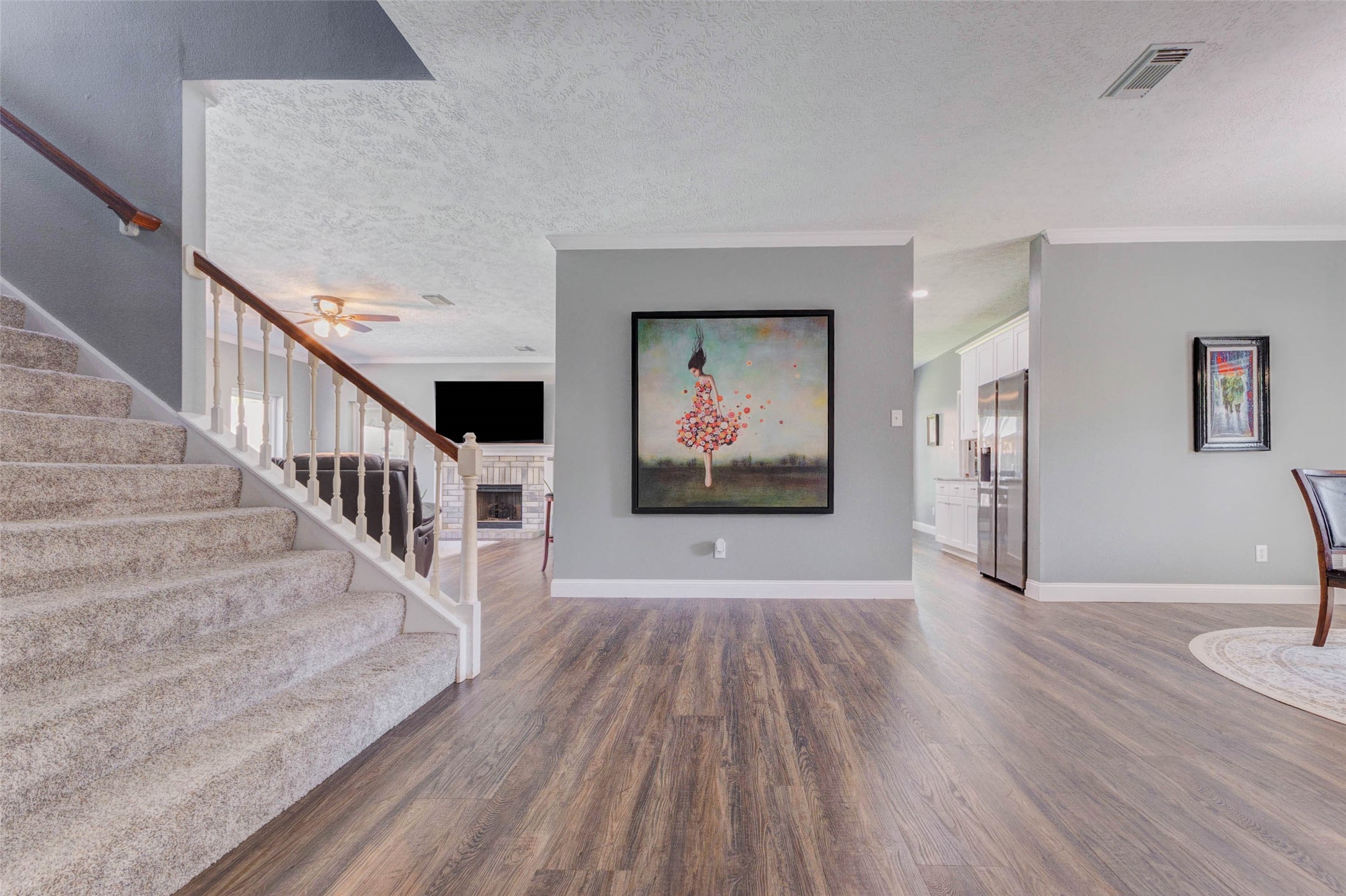 9215 Landry Boulevard Spring, TX 77379 - Photo 8 of 42 The thoughtfully designed layout offers easy flow throughout the main living areas, with the staircase leading to the upstairs bedrooms and bathrooms while the dining area is conveniently positioned just off the kitchen.