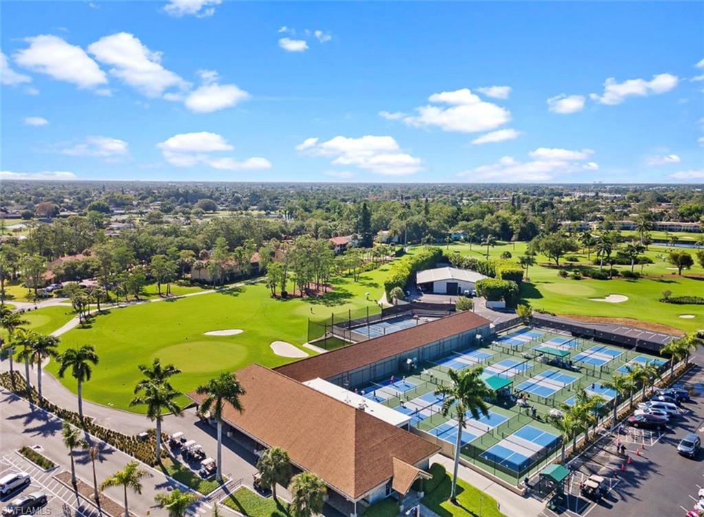 197 Harrison Road, Unit 3 Naples, FL 34112 - Photo 12 of 14 Drone / aerial view of a local golf course and a tree filled landscape