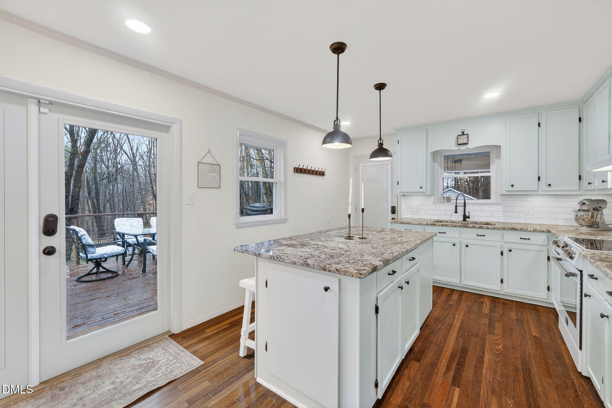 2808 Carpenter Pond Road Raleigh, NC 27613 - Photo 13 of 49 a kitchen with stainless steel appliances granite countertop a sink stove and wooden floor