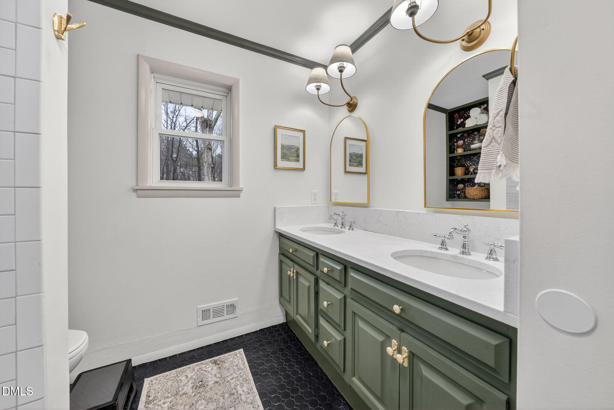 2808 Carpenter Pond Road Raleigh, NC 27613 - Photo 19 of 49 a bathroom with a double vanity sink and a mirror