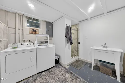 a utility room with cabinets washer and dryer