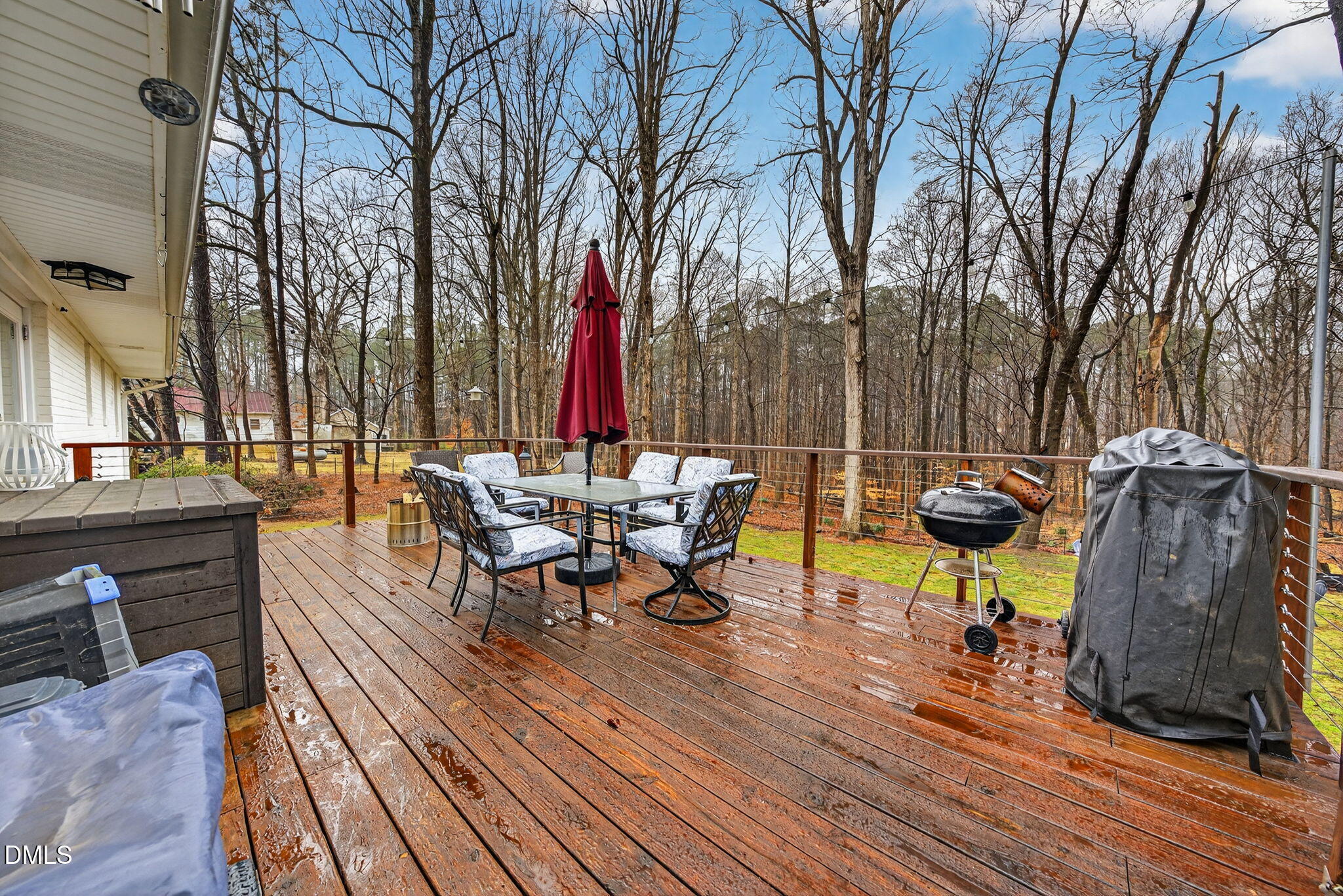 2808 Carpenter Pond Road Raleigh, NC 27613 - Photo 43 of 49 a view of a patio with table and chairs couches with wooden floor and fence