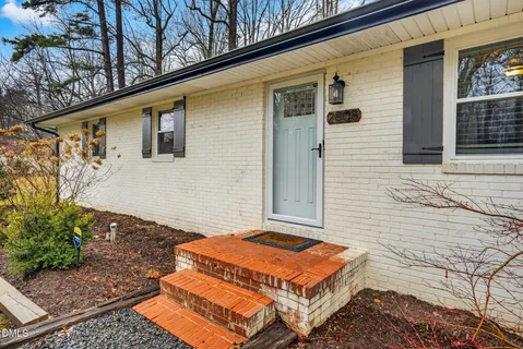 a backyard of a house with yard and outdoor seating