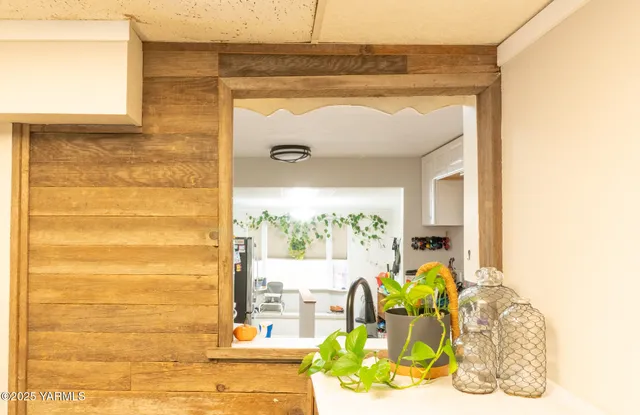 a kitchen with a stove a sink and a window