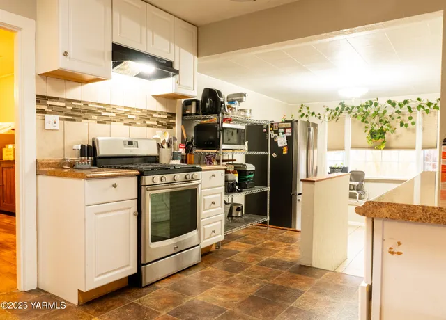 a kitchen with a stove a refrigerator and a sink