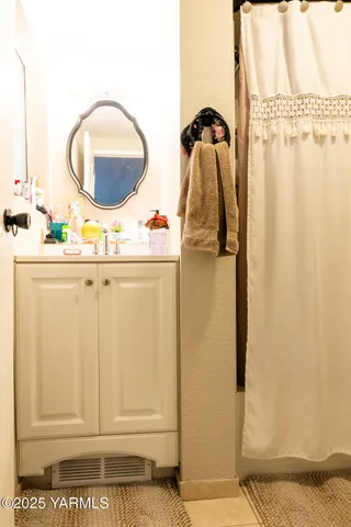 a bathroom with a toilet sink and vanity