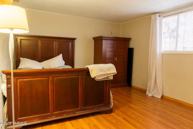 a bedroom with a bed and a shower