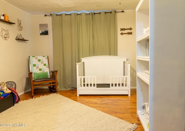a bedroom with furniture and a large window