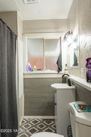 a bathroom with a shower and a sink
