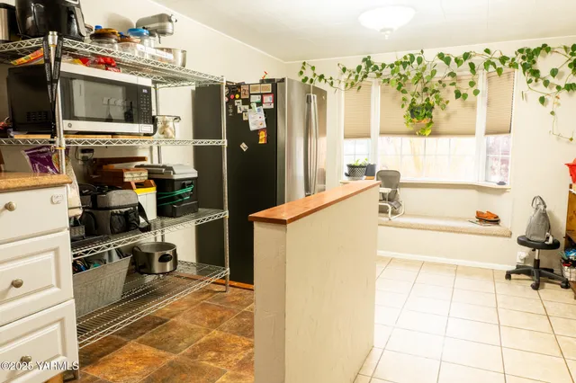 a kitchen with a refrigerator and a sink