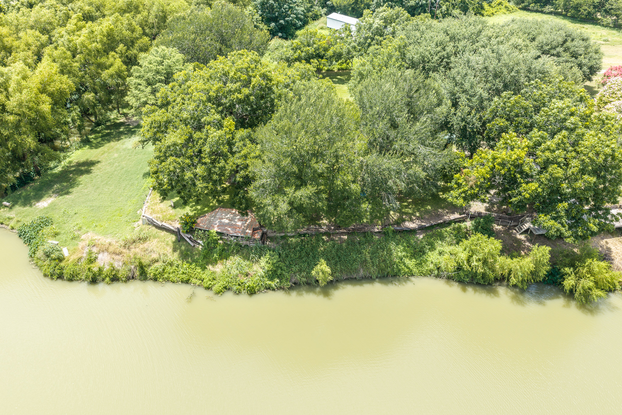 Tbd Goodwin Road Gonzales, TX 78629 - Photo 25 of 33 A tranquil waterfront lot offers verdant surroundings and direct access to the water.