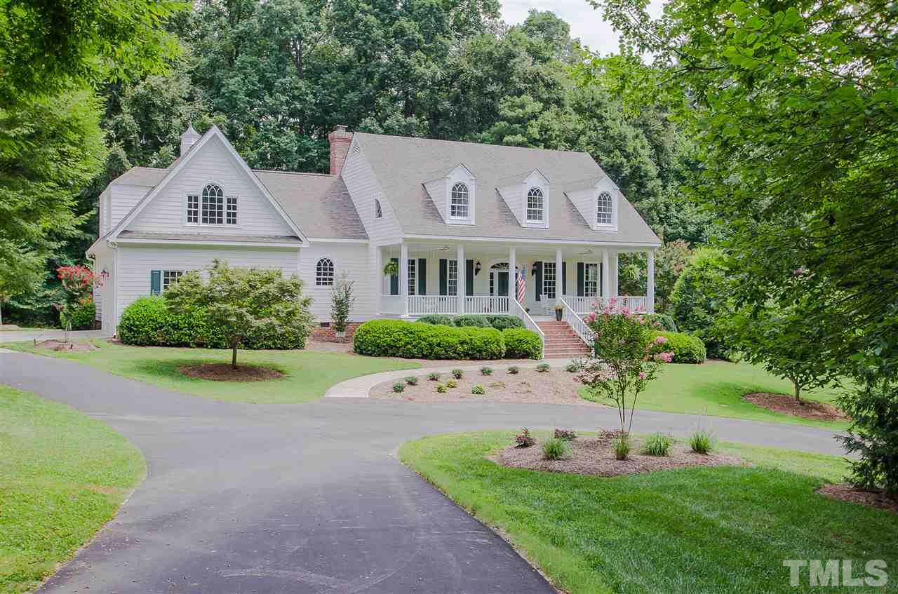 12016 Shooting Club Road Raleigh, NC 27613 - Photo 2 of 25 a front view of a house with a garden and plants