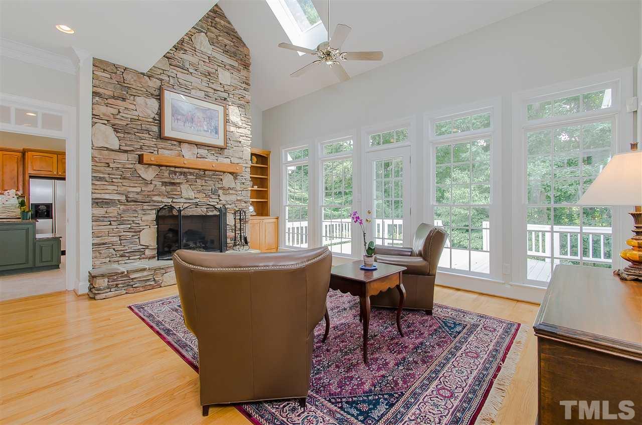 12016 Shooting Club Road Raleigh, NC 27613 - Photo 13 of 25 a living room with furniture and a fireplace