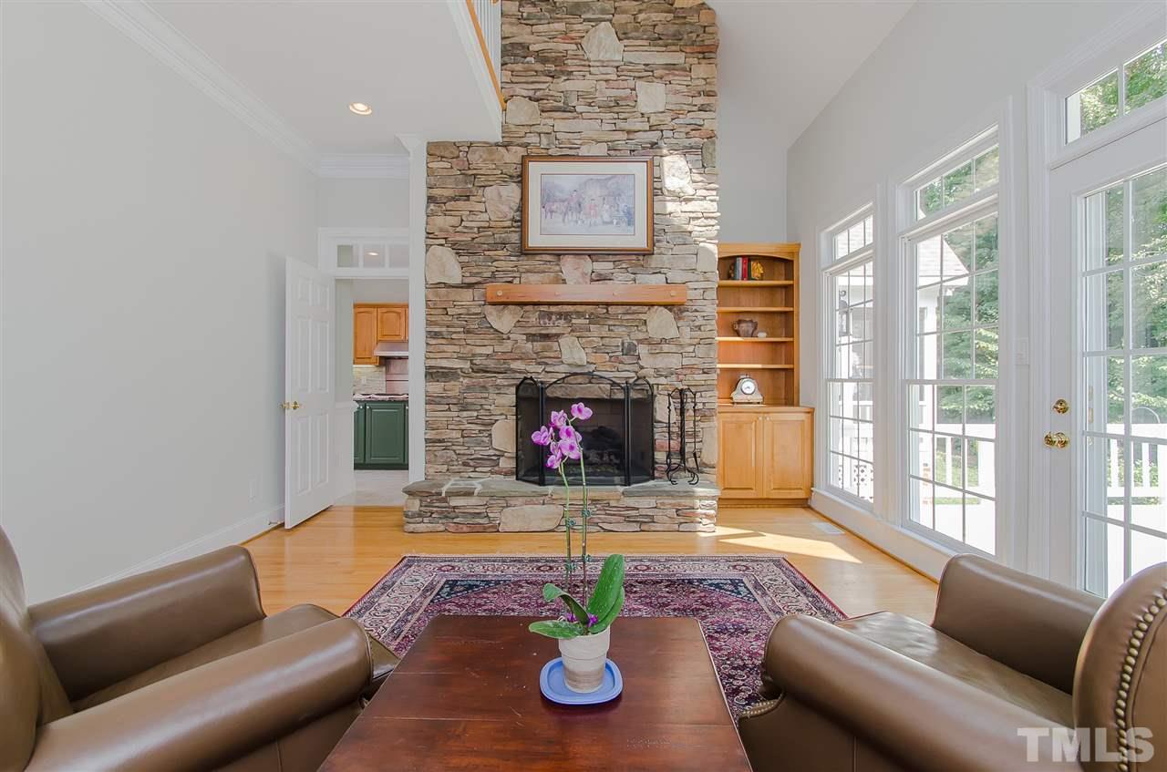 12016 Shooting Club Road Raleigh, NC 27613 - Photo 14 of 25 a living room with furniture and a fireplace