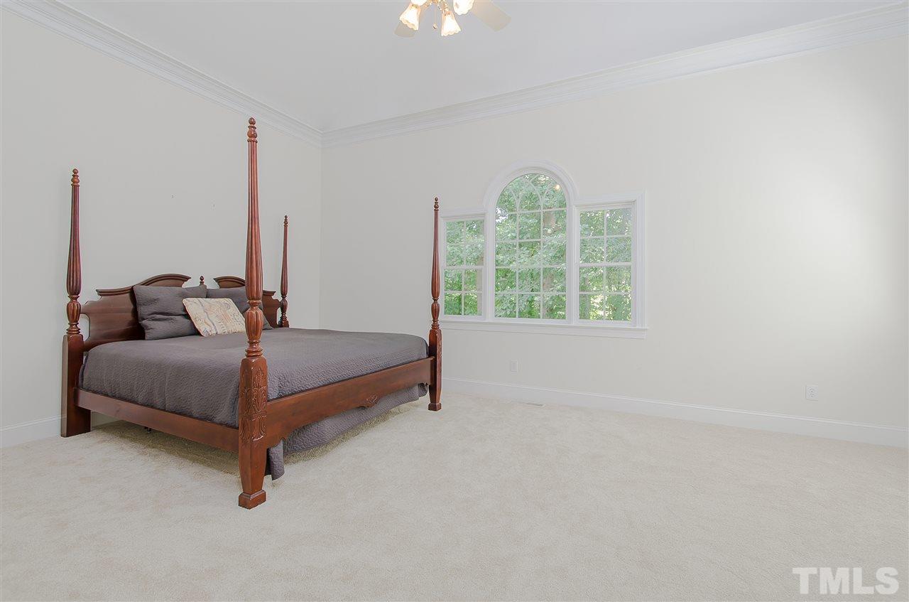 12016 Shooting Club Road Raleigh, NC 27613 - Photo 15 of 25 a bedroom with a bed and window