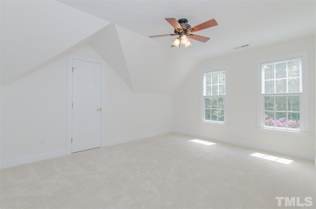 12016 Shooting Club Road Raleigh, NC 27613 - Photo 19 of 25 an empty room with windows and fan