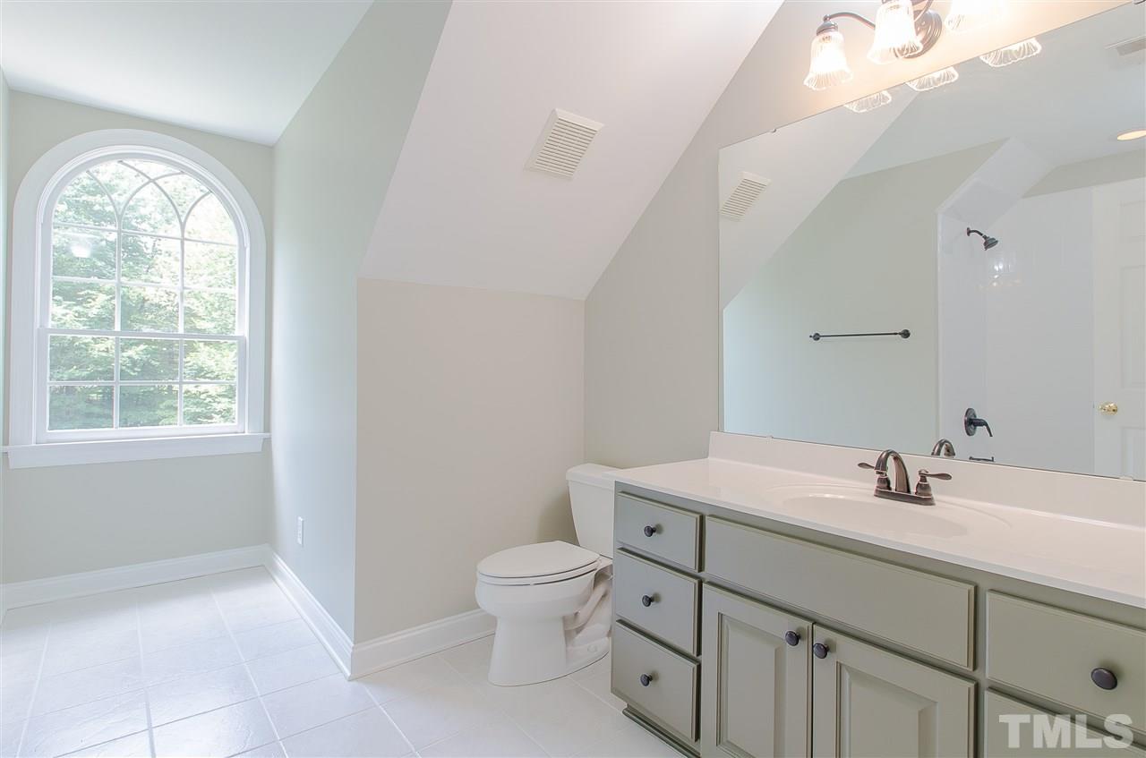 12016 Shooting Club Road Raleigh, NC 27613 - Photo 20 of 25 a bathroom with a toilet sink and mirror