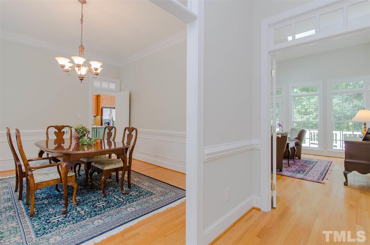 12016 Shooting Club Road Raleigh, NC 27613 - Photo 6 of 25 a view of a dining room with furniture a rug and wooden floor