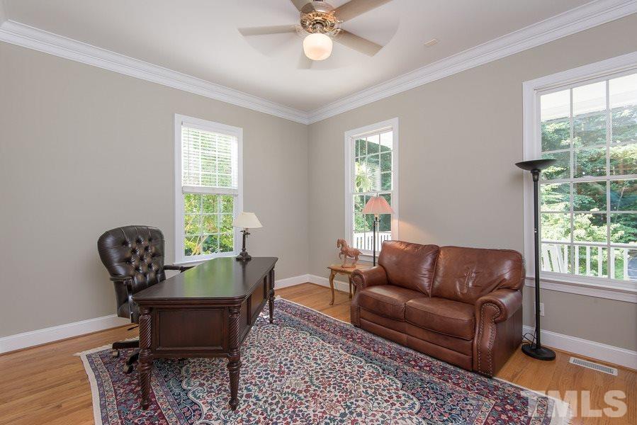 12016 Shooting Club Road Raleigh, NC 27613 - Photo 7 of 25 a living room with furniture and a window