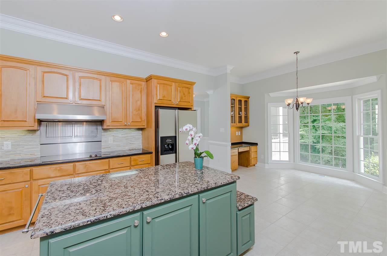 12016 Shooting Club Road Raleigh, NC 27613 - Photo 8 of 25 a kitchen with stainless steel appliances granite countertop a sink a stove and cabinets