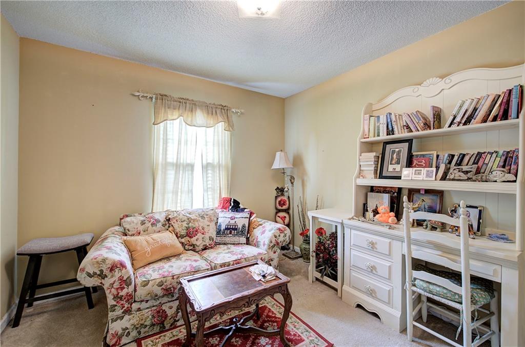218 Gilreath Road Southeast Cartersville, GA 30121 - Photo 18 of 27 a bedroom with furniture and a book shelf