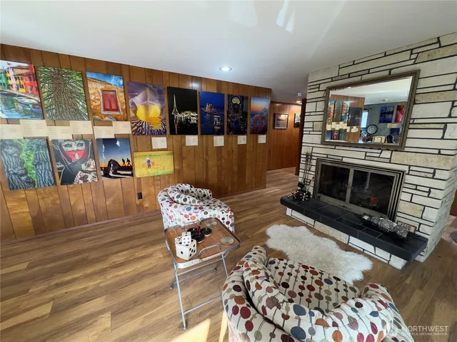 a living room with furniture a rug and kitchen view