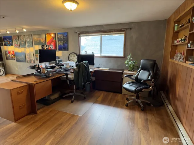 a view of a workspace with furniture and a window