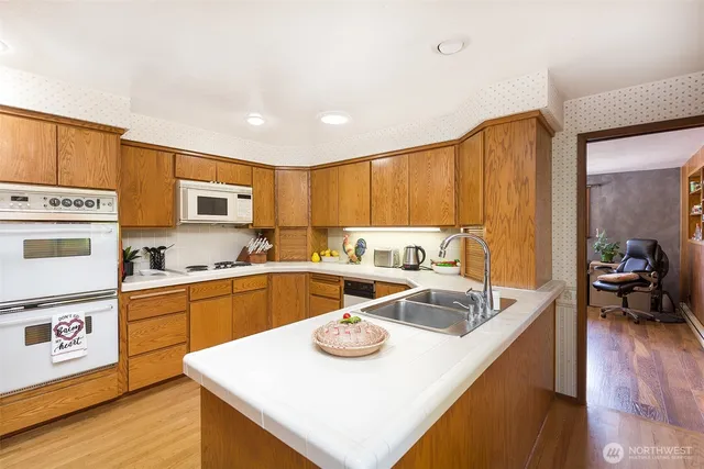 a kitchen with stainless steel appliances granite countertop a sink a stove and refrigerator