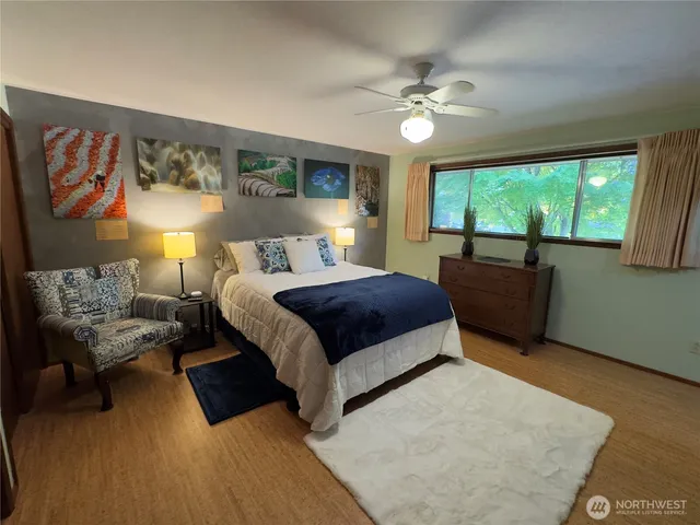 a bedroom with a large bed and a chandelier