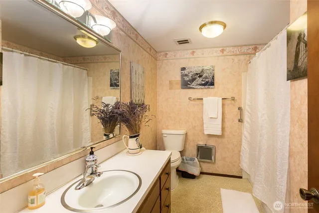 a bathroom with a sink a mirror and a shower