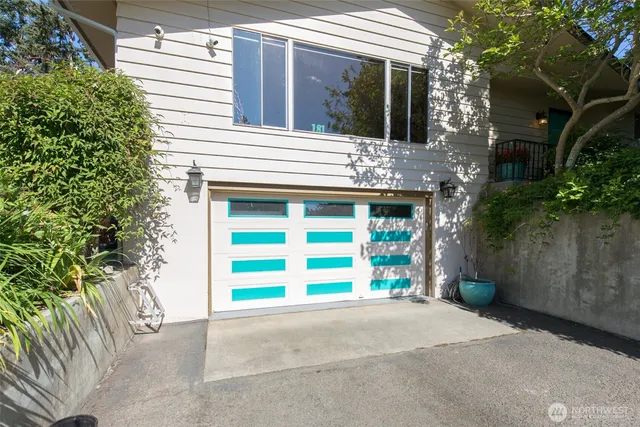 a view of a house with a yard and garage